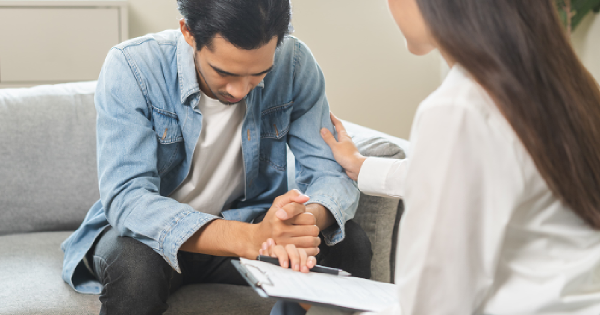 A concerned man speaks with a healthcare professional during a consultation for Testosterone Treatment in Annandale, VA.